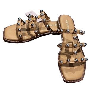 Women’s tan slip on sandals with silver tone details size 7.5